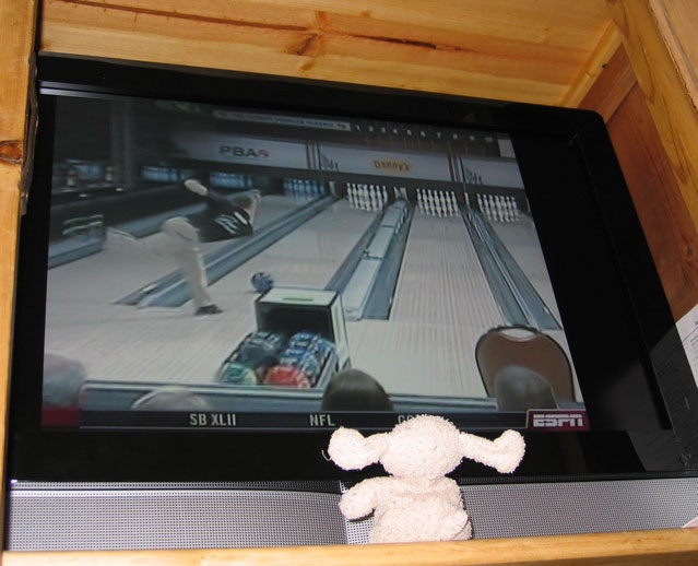 Mickey watching bowling on tv